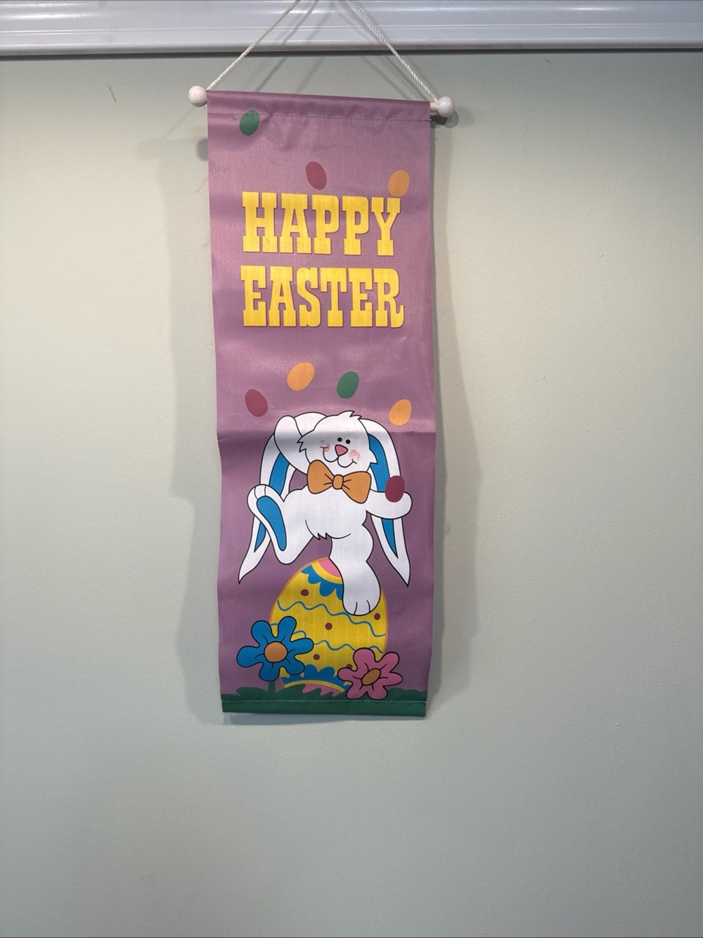 Vintage purple happy easter wall decor with easter bunny eggs and flowers
